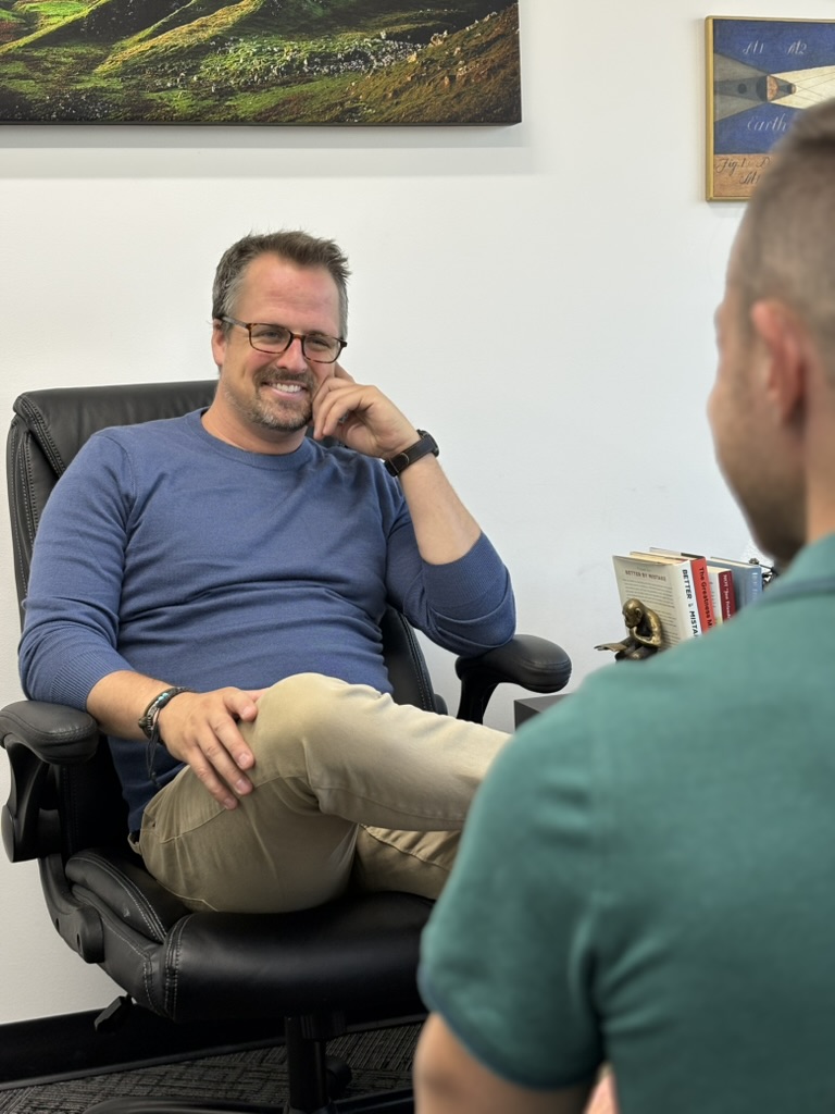Hugh Pinnock meeting with a client in his Salt Lake City office